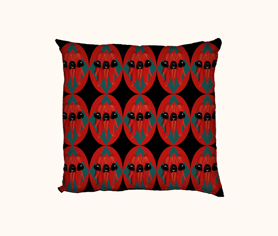 cushion featuring Sturt's desert pea flower on a background of diamonds and ovals in red, teal and black