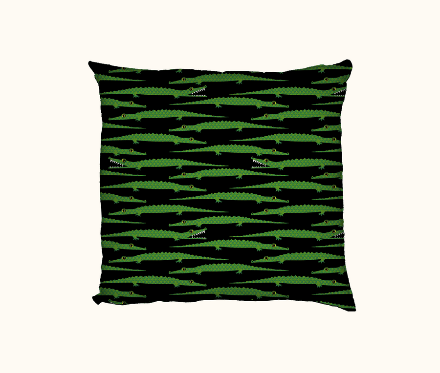 cushion with bright green saltwater crocodiles against a black background