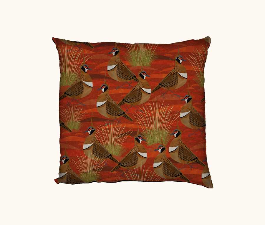 45cm square cushion featuring a pattern of spinifex pigeons and pigeons against an orange desert theme background