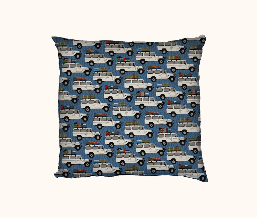 cushion covered in troop-carriers with roof-racks packed for a holiday on a blue wavy background