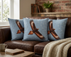 cushions featuring one large wedge-tailed eagle on a mottled sky blue background on a brown leather couch