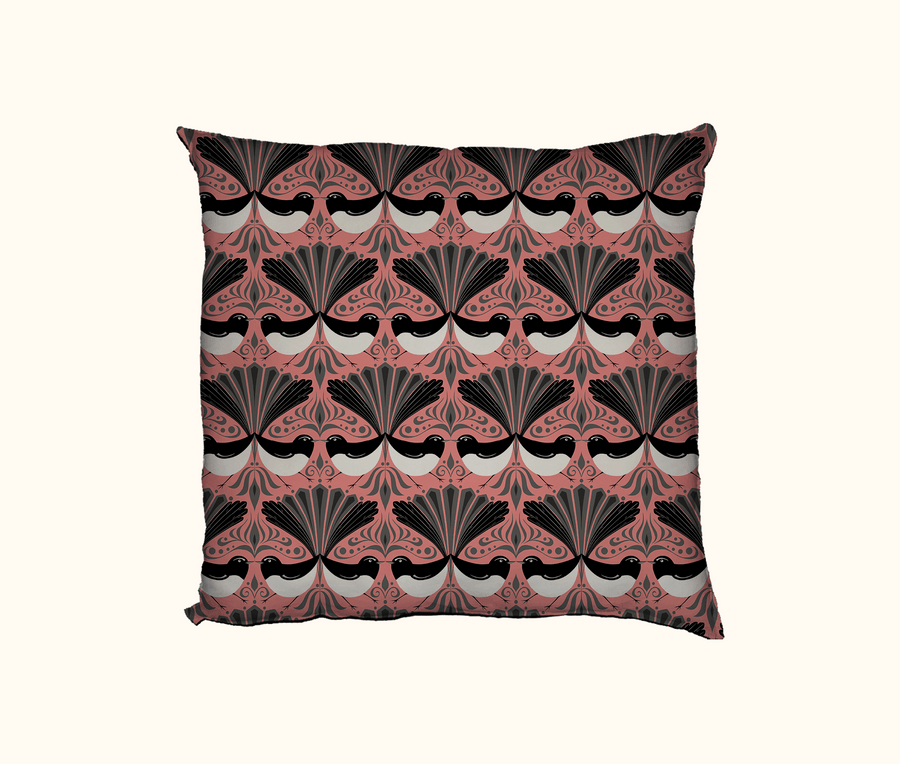 cushion with black, white and grey willie wagtail pattern on a coral background