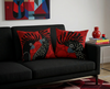 cushions with stylised red-tailed black cockatoo heads on a background of large red spots on a black couch