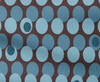 fabric with a pattern of blue dots on brown