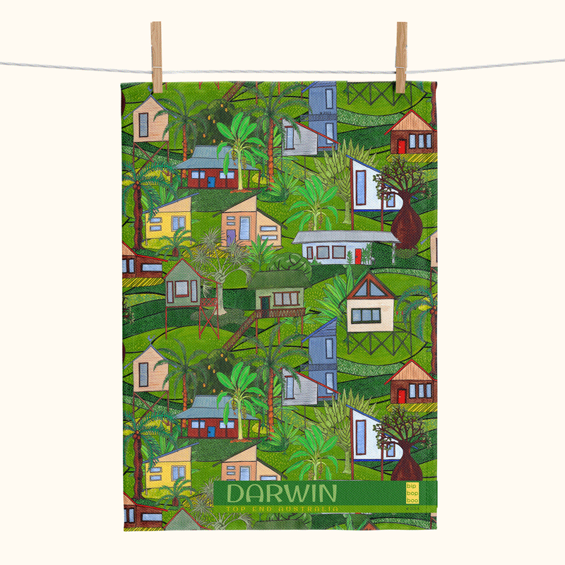 Linen tea towel with an all-over pattern of tropical houses in a lush landscape