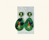 acrylic earrings showing azure kingfishers perched on sacred lotus seed pods