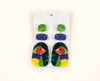 acrylic earrings featuring stylised Gouldian finches