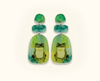 acrylic drop earrings featuring green tree frogs