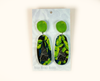 acrylic earrings featuring flying foxes hanging upside down among bright green leaves