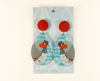 acrylic earrings featuring stylised zebra finches