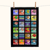 a brightly coloured linen teatowel with highly stylised and very round finches in squares