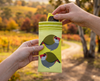 Image shows a pair of yellow glasses being removed from a canvas glasses slip case featuring two very round highly stylised red-browed finches on a yellow background against an Australian autumnal scene