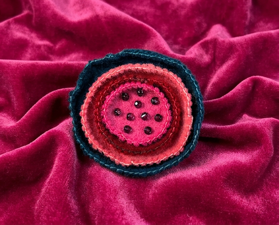 red, pink, coral and deep blue layered felt flower brooch with beaded centre