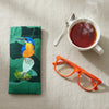Canvas glasses slip case featuring a stylised azure kingfhisher perced on a sacred lotus pod.
