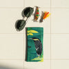 Canvas glasses slip case featuring a stylised black bittern standing on a rock in a stream.