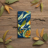 Canvas glasses slip case featuring stylised blue faced honey eater and scarlet gum blossom and leaves on a deep blue background.