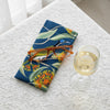 Canvas glasses slip case featuring stylised blue faced honey eater and scarlet gum blossom and leaves on a deep blue background.