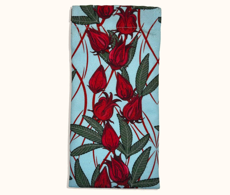 Canvas glasses slip case with a pale blue background and red rosella blossoms and leaves