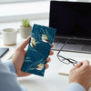 Canvas glasses slip case featuring stylised double barred finches and blue stalks on feathery grass on a blue background.