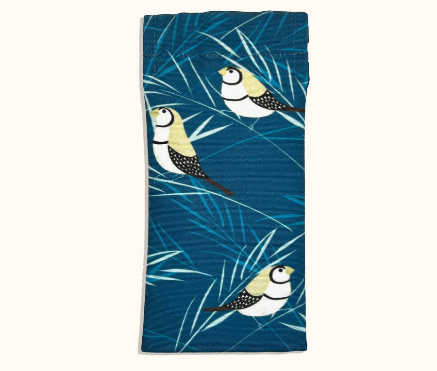 Canvas glasses slip case featuring stylised double barred finches and blue stalks on feathery grass on a blue background.