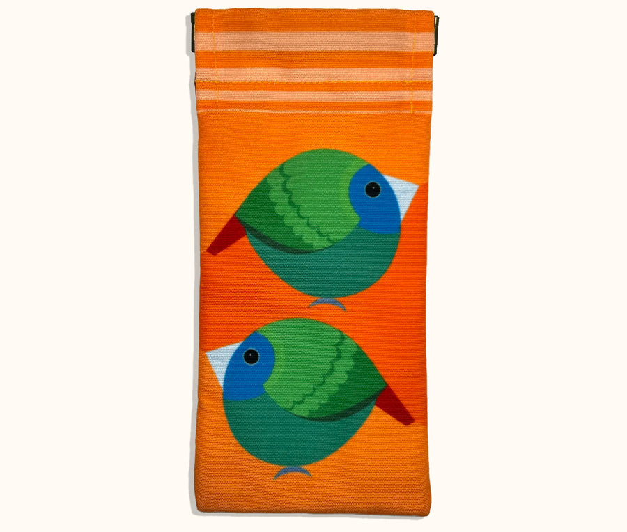 Canvas glasses slip case featuring very round and highly stylised blue-faced parrotfinches on an orange background