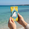 Canvas glasses slip case featuring a stylised fairy penguin within a blue and yellow ogee pattern