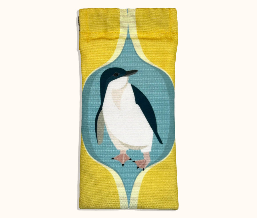 Canvas glasses slip case featuring a stylised fairy penguin within a blue and yellow ogee pattern