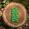 Canvas glasses slip case featuring stylised green tree ants on a green striped background