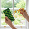Canvas glasses slip case featuring stylised green tree ants on a green striped background