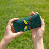 Canvas glasses slip case featuring two stylised gouldian finches on a branch against a leafy teal and green background