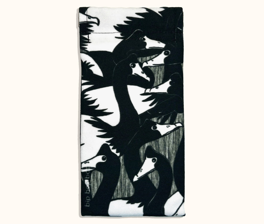 Canvas glasses slip case covered with a black and white magpie goose design
