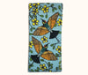 A canvas glasses slip case featuring coloured lino prints of two rainbow bee-eaters surrounded by kapok flowers