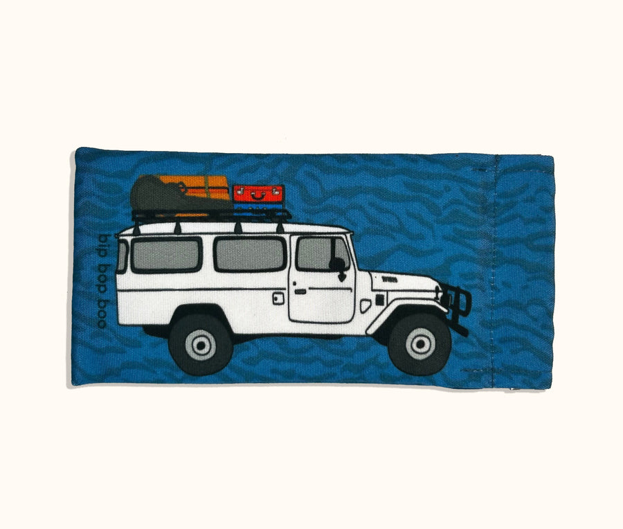 Canvas glasses slip case featuring a troop carrier with a loaded roof rack on a blue mottled background