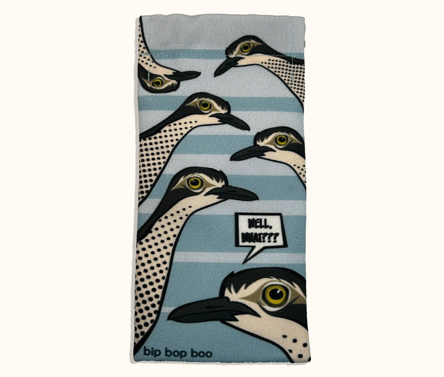Canvas glasses slip case featuring several pop art bush stone curlews with a speech bubble saying 'Well, what?' against a pale blue striped background.