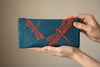 Fabric glasses case, featuring a red dragonfly on a royal blue patterned background.