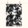 black and white linen tea towel covered with magpie geese