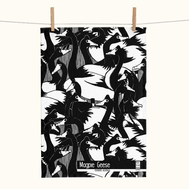 black and white linen tea towel covered with magpie geese