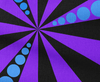 Patterned fabric with purple and black rays and blue circles.