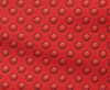 red fabric with pattern of ogees and circular seeds