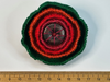 Red and green layered felt brooch with a single flat bead at its centre
