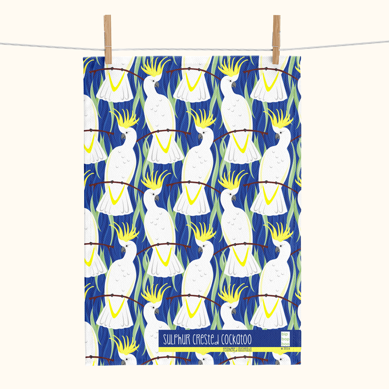 linen tea towel featuring a stylised all-over sulphur-crested cockatoo design with a blue background