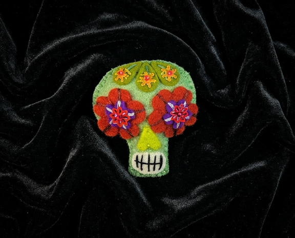 Mint green sugar skull felt brooch with red and purple flower eyes