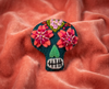 Sugar skull felt brooch with coral and red flower eyes