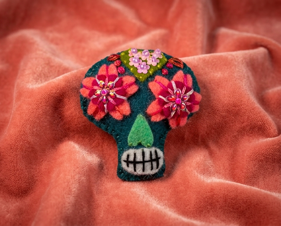 Sugar skull felt brooch with coral and red flower eyes