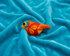 Bright orange and yellow finch felt brooch with a blue and yellow eye