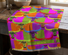 colourful linen tea towel with buffalo-heads in a pop-art design draped on a kitchen bench