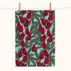 Linen tea towel with pattern of rosella blossoms and leaves on a pale blue background
