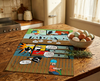 linen tea towel printed with a comic book style story about peewees on a timber table with a bowl of eggs