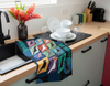 colourful linen tea towel featuring stylised drawings of 12 Australian cockatoos