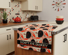 linen tea towel printed with a stylistic mid-century modern flame-backed fiddler crab pattern in a retro style kitchen